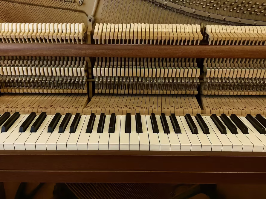 Close-up of upright piano key and hammer mechanism showing how sticky keys can be fixed without a technician