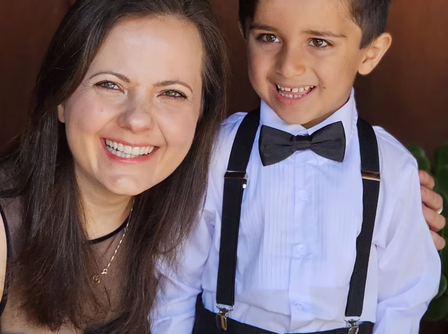 K&M Music School student and teacher smiling at a community event.