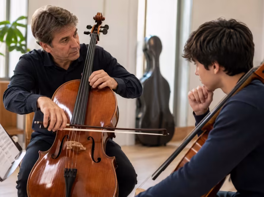 Private cello teacher demonstrating technique to a student at K&M Music Company in San Diego.