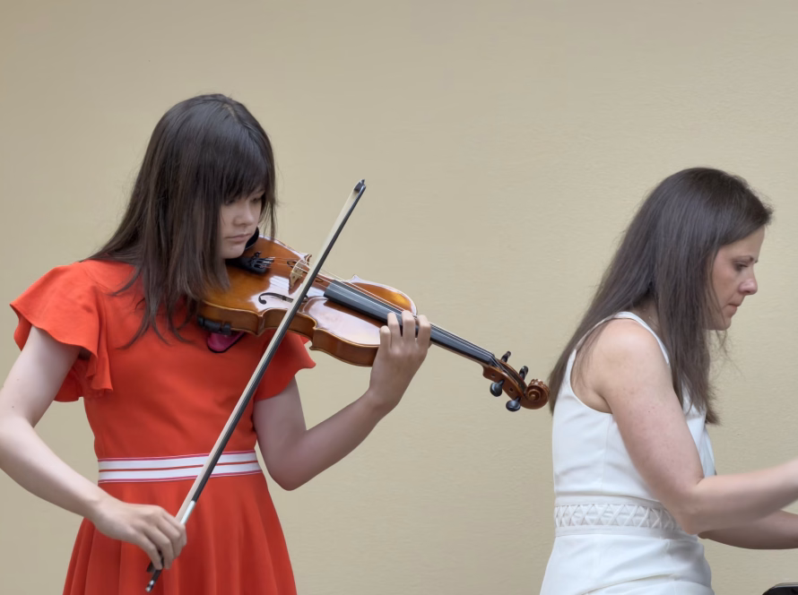 Violin student performing with piano accompaniment at K&M Music School in San Diego.