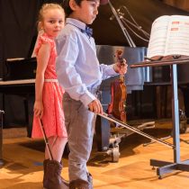 After performing duet for two violins getting a lot of applause - K&M Music School Violin Lessons for Kids and Adults in San Diego