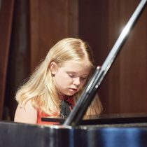 Intermediate Piano student performs by memory at the school recital - K&M Music School Piano Lessons for Kids and Adults in San Diego